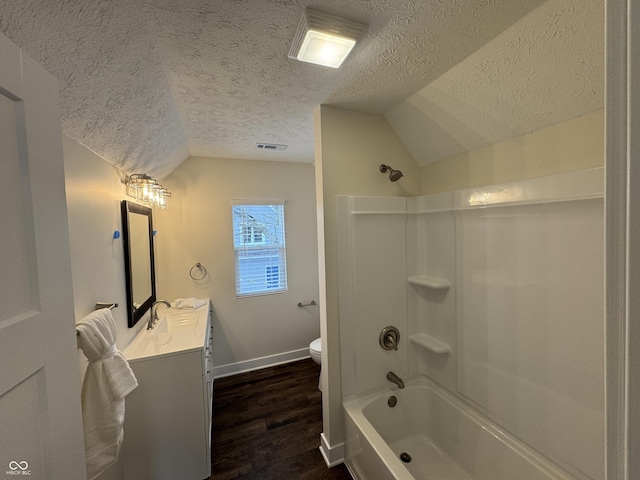 full bath with vaulted ceiling, a textured ceiling, toilet, and vanity