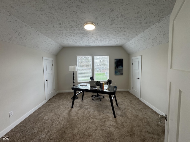 office area with lofted ceiling, a textured ceiling, carpet floors, and baseboards