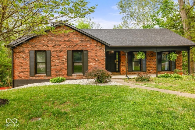 ranch-style house with brick siding, a front yard, and roof with shingles