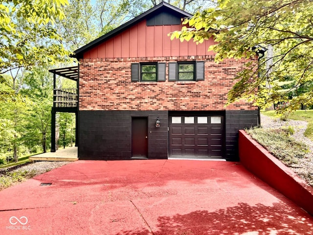 view of front of property featuring brick siding, an attached garage, and driveway