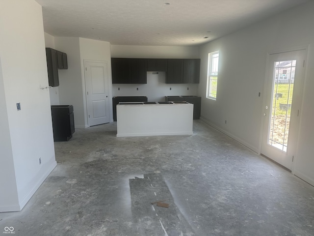 1656 Winn Ct, Fortville, IN 46040 - kitchen featuring a center island, concrete floors, and baseboards