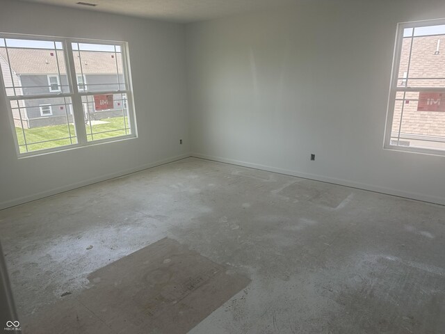 1656 Winn Ct, Fortville, IN 46040 - unfurnished room featuring unfinished concrete floors, healthy amount of natural light, and baseboards
