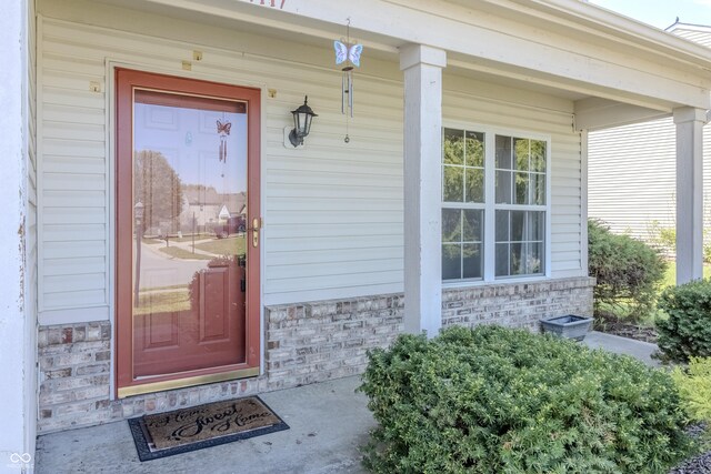 doorway to property with covered porch