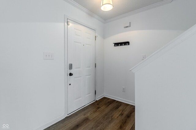 entrance foyer with crown molding, baseboards, and dark wood finished floors