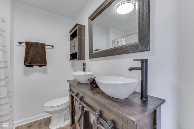 91 Crestview Dr, Greenwood, IN 46143 - full bath with wood finished floors, vanity, toilet, and baseboards