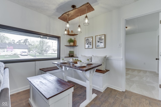 91 Crestview Dr, Greenwood, IN 46143 - dining room featuring a textured ceiling, wood finished floors, breakfast area, and a wainscoted wall