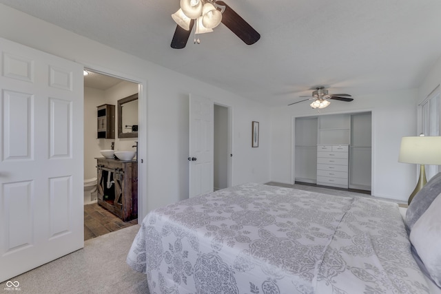 91 Crestview Dr, Greenwood, IN 46143 - bedroom with baseboards, a ceiling fan, wood finished floors, a closet, and connected bathroom
