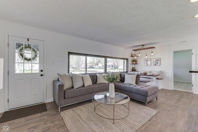 91 Crestview Dr, Greenwood, IN 46143 - living area featuring wood finished floors, a textured ceiling, and baseboards
