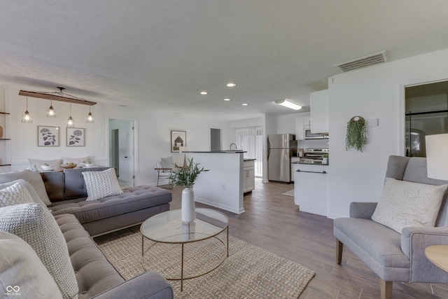 91 Crestview Dr, Greenwood, IN 46143 - living room with recessed lighting, wood finished floors, visible vents, and baseboards
