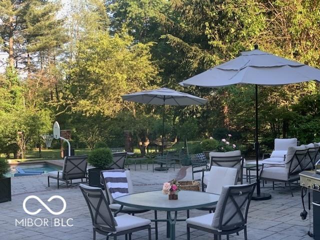 view of patio featuring an outdoor pool and outdoor dining area