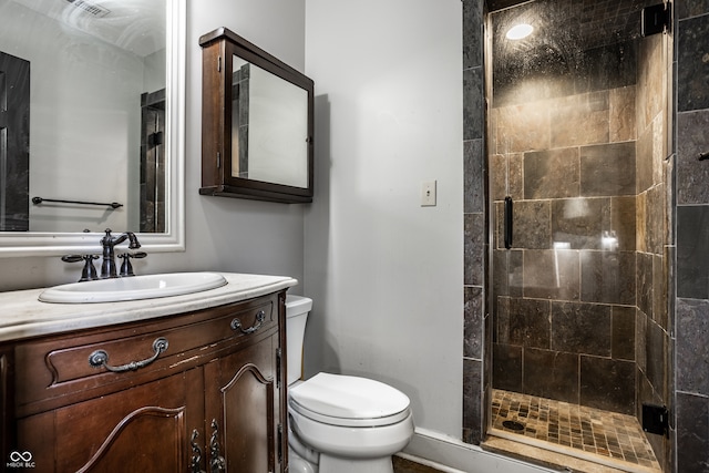 full bathroom with vanity, toilet, and a stall shower