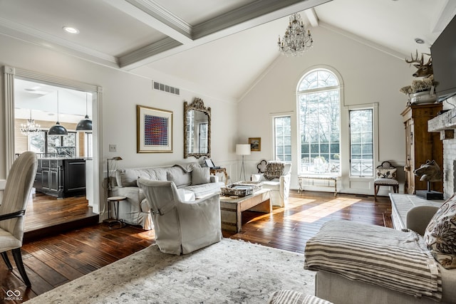 living area with visible vents, beam ceiling, a chandelier, and dark wood finished floors