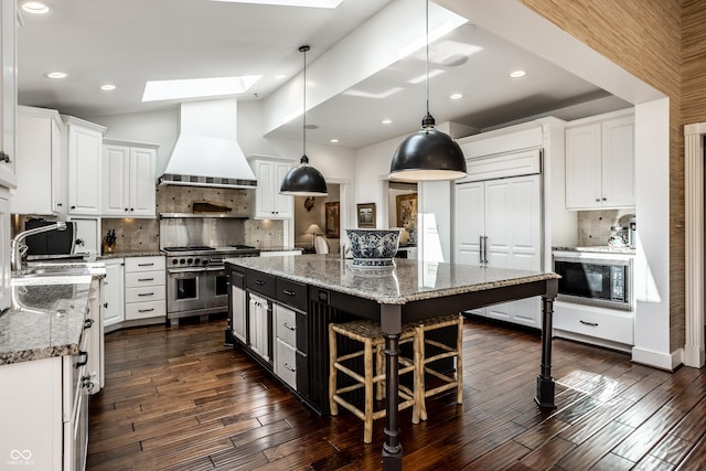 kitchen featuring double oven range, white cabinetry, decorative backsplash, black microwave, and custom exhaust hood