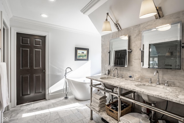 bathroom featuring ornamental molding, recessed lighting, a sink, and a freestanding bath