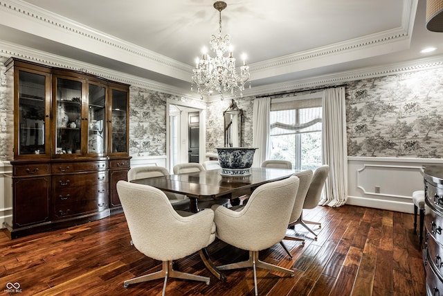 dining room with crown molding, a chandelier, wallpapered walls, dark wood-style flooring, and wainscoting