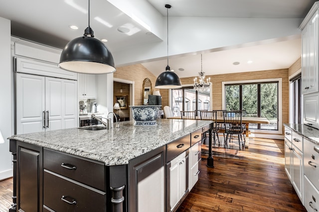 kitchen with lofted ceiling, dark wood-type flooring, and white cabinetry