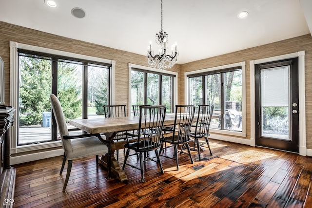 dining area featuring baseboards, recessed lighting, hardwood / wood-style flooring, and a notable chandelier