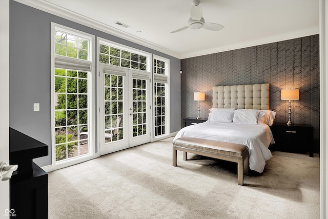 carpeted bedroom featuring access to outside, crown molding, an accent wall, wallpapered walls, and a ceiling fan