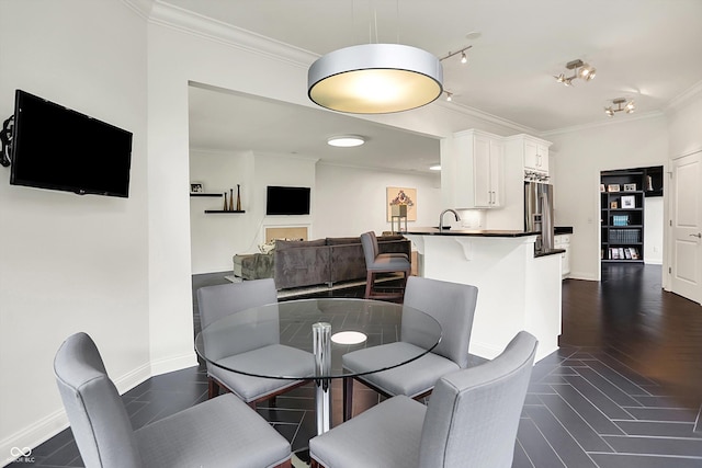 dining area featuring crown molding and baseboards