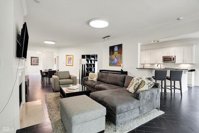 living room with crown molding and baseboards
