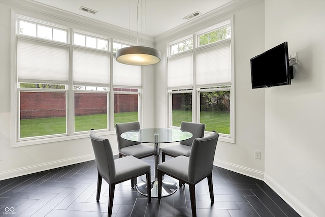 dining space featuring baseboards and crown molding