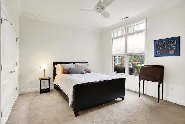 bedroom with light colored carpet, ornamental molding, baseboards, and ceiling fan