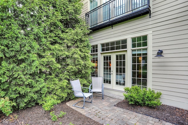 view of patio with french doors and a balcony