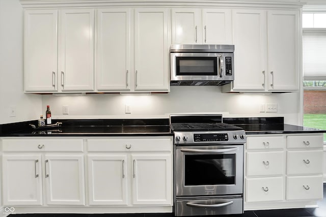 kitchen with appliances with stainless steel finishes and white cabinetry