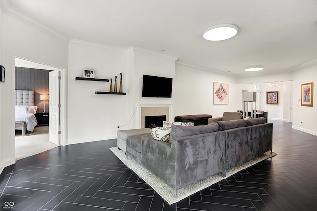 living room with ornamental molding, baseboards, and a fireplace