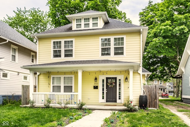 3133 Ruckle St, Indianapolis, IN 46205 - traditional style home with a porch, roof with shingles, and fence