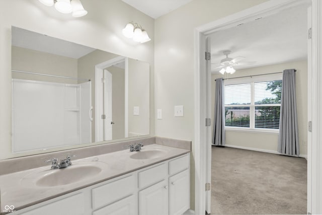 full bath with double vanity, a sink, baseboards, and a ceiling fan