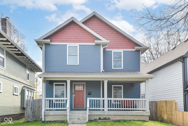 craftsman inspired home with a porch and fence