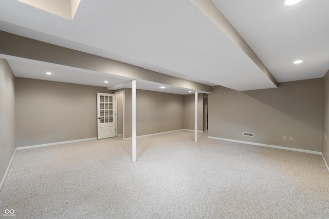 finished below grade area with recessed lighting, baseboards, visible vents, and light colored carpet
