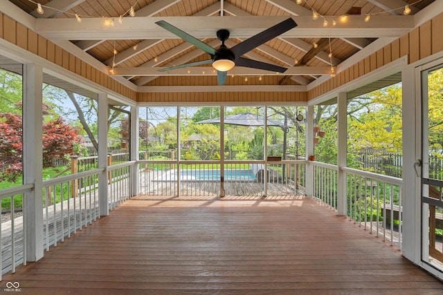 unfurnished sunroom with ceiling fan