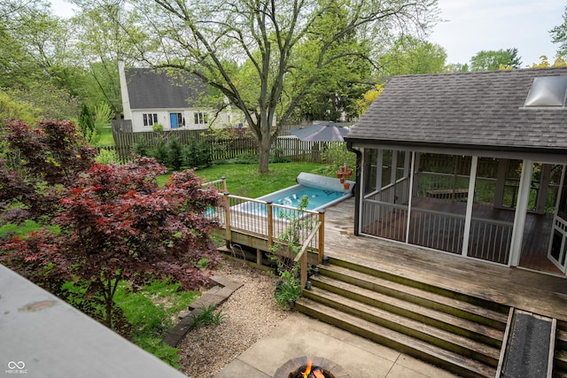 wooden terrace featuring a fenced backyard and an outdoor pool