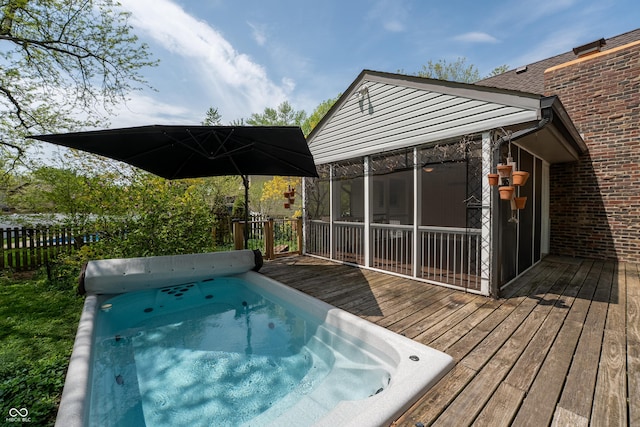 deck featuring a sunroom and fence