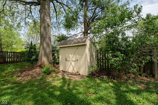 view of shed featuring fence