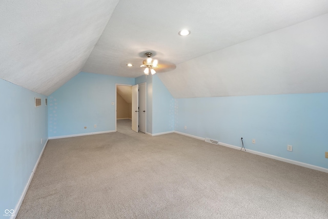 bonus room with visible vents, carpet flooring, baseboards, and lofted ceiling