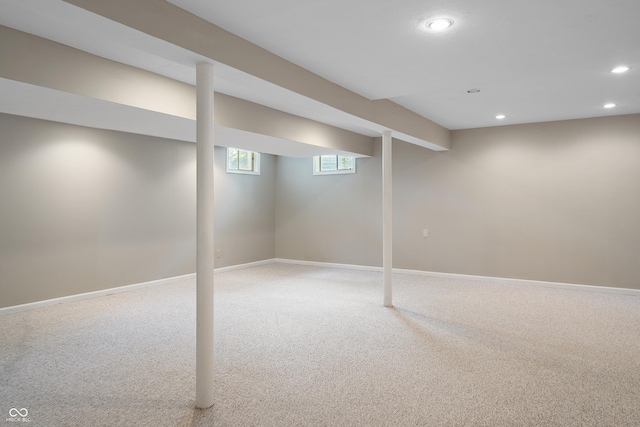 below grade area featuring recessed lighting, baseboards, and light carpet