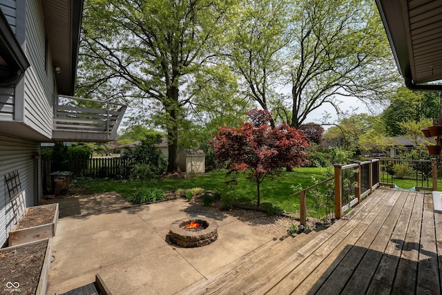 deck featuring a patio, a yard, an outdoor fire pit, and fence private yard