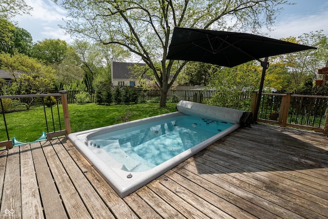 view of pool featuring a fenced backyard, a wooden deck, and a yard
