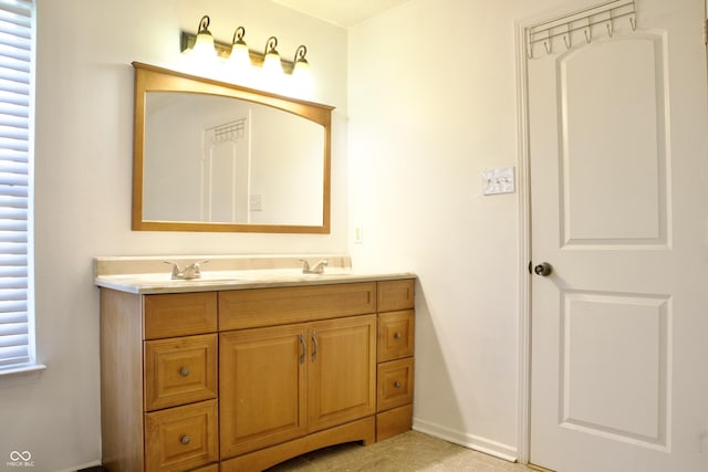 5236 Skipping Stone Dr, Indianapolis, IN 46237 - bathroom featuring baseboards, tile patterned floors, double vanity, and a sink