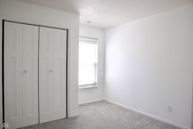 5236 Skipping Stone Dr, Indianapolis, IN 46237 - unfurnished bedroom featuring baseboards, carpet floors, a textured ceiling, and a closet