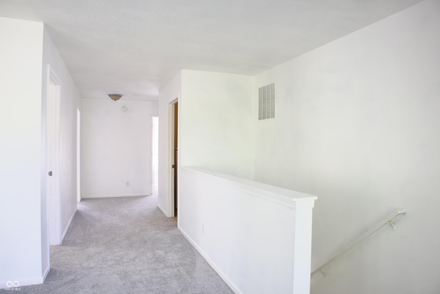 5236 Skipping Stone Dr, Indianapolis, IN 46237 - corridor featuring baseboards, visible vents, carpet floors, and an upstairs landing