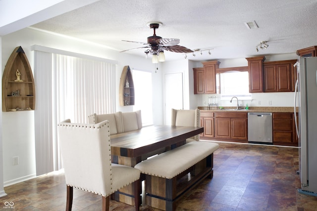 5236 Skipping Stone Dr, Indianapolis, IN 46237 - dining space featuring a ceiling fan, visible vents, a textured ceiling, and baseboards