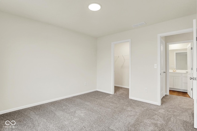2712 Glade Ave, Plainfield, IN 46168 - unfurnished bedroom featuring carpet flooring, a spacious closet, baseboards, and a closet