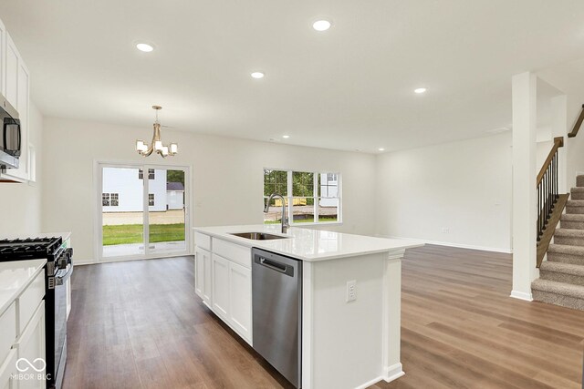 2712 Glade Ave, Plainfield, IN 46168 - kitchen with a sink, stainless steel appliances, a chandelier, wood finished floors, and recessed lighting