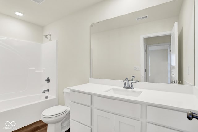 2712 Glade Ave, Plainfield, IN 46168 - full bathroom featuring toilet, vanity, wood finished floors, and tub / shower combination