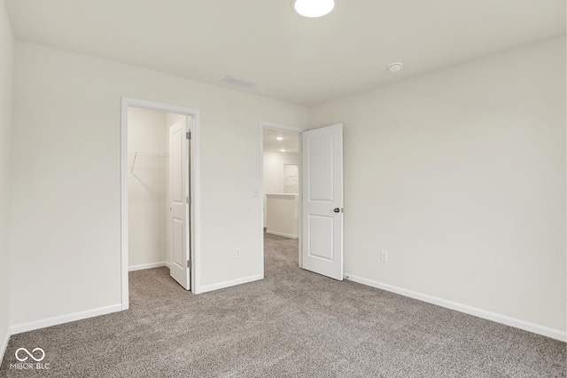 2712 Glade Ave, Plainfield, IN 46168 - unfurnished bedroom with carpet, a spacious closet, baseboards, and a closet