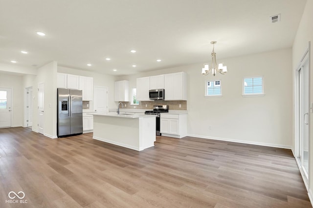 2712 Glade Ave, Plainfield, IN 46168 - kitchen featuring appliances with stainless steel finishes, a chandelier, plenty of natural light, light wood-style flooring, and recessed lighting